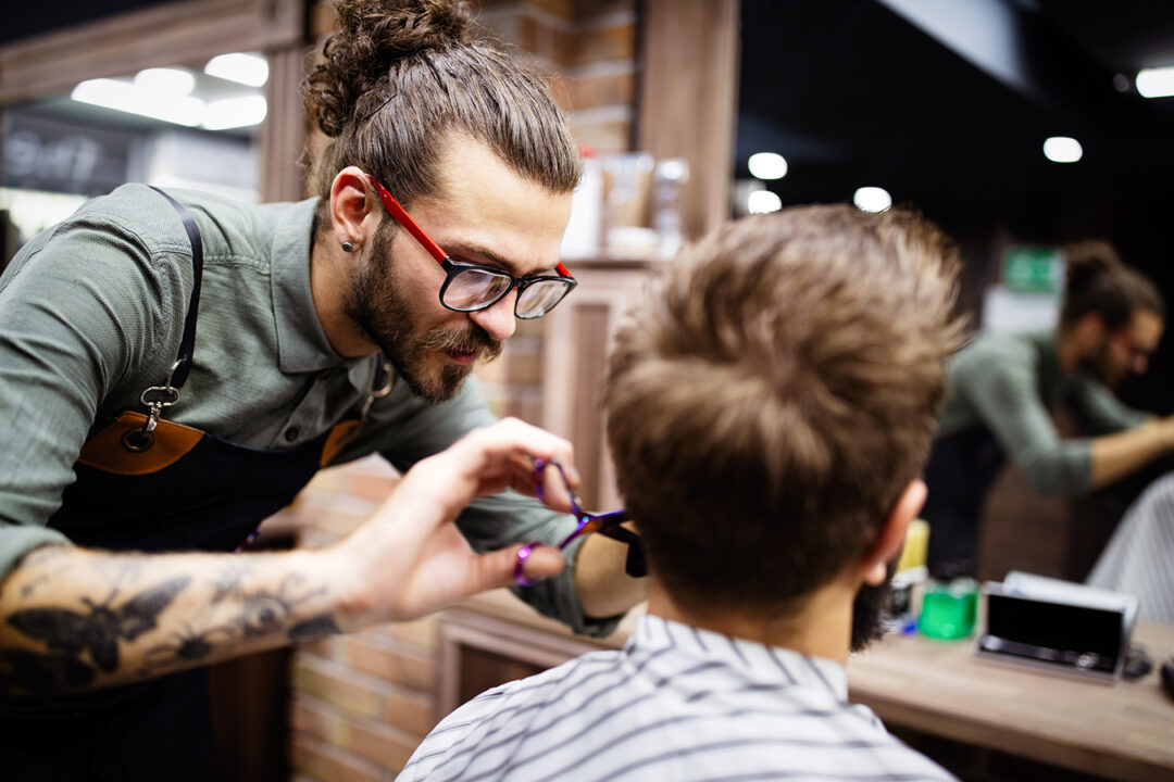 Man client during beard and moustache grooming in barber shop